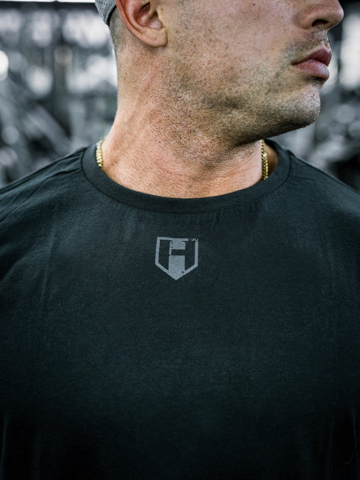 IFBB Pro Bodybuilder Martin Fitzwater wearing a black long-sleeve shirt with text in a gym setting#color_black
