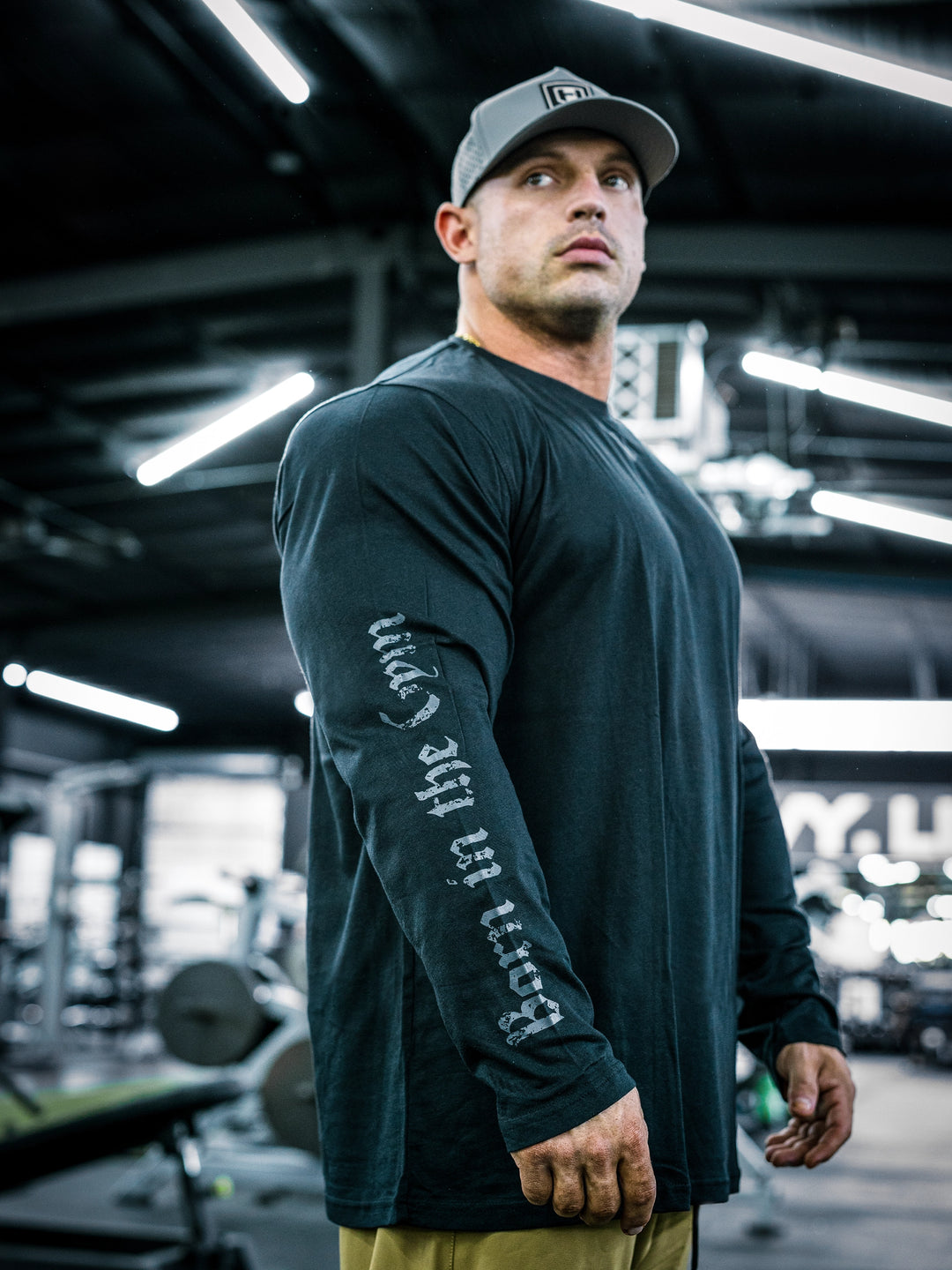 IFBB Pro Bodybuilder Martin Fitzwater wearing a black long-sleeve shirt with text in a gym setting#color_black
