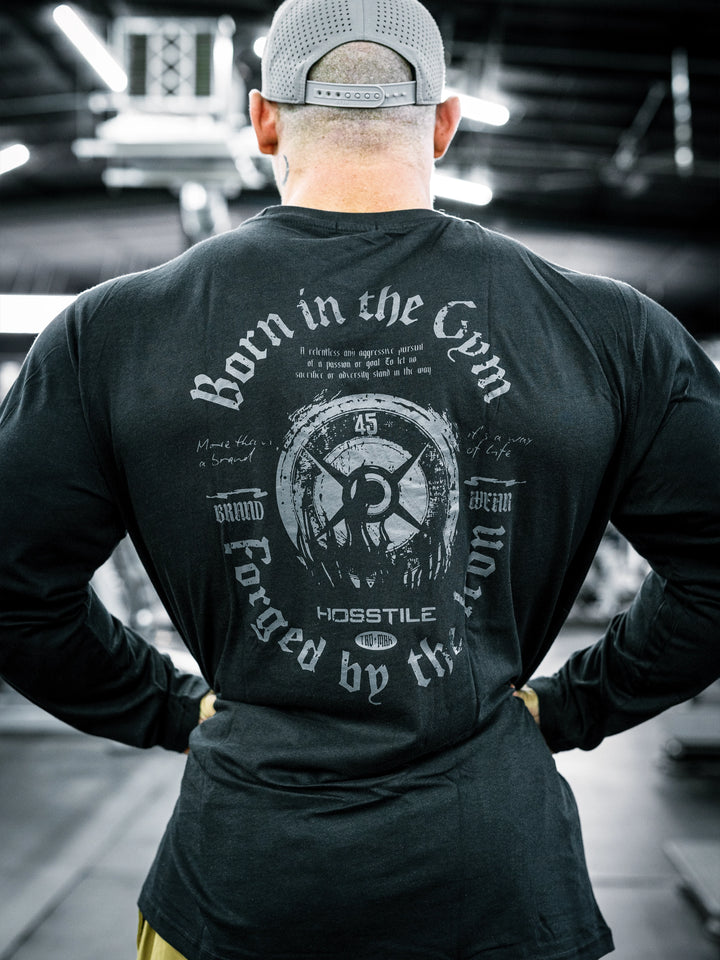 IFBB Pro Bodybuilder Martin Fitzwater wearing a black long-sleeve shirt with text in a gym setting#color_black