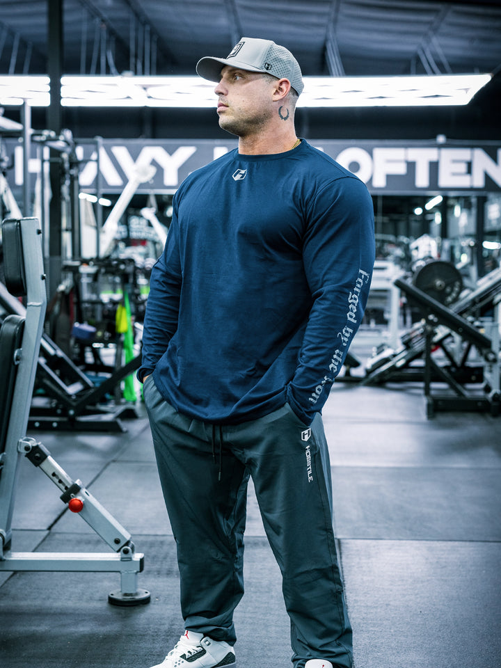 IFBB Pro Bodybuilder Martin Fitzwater wearing a black long-sleeve shirt with text in a gym setting#color_navy