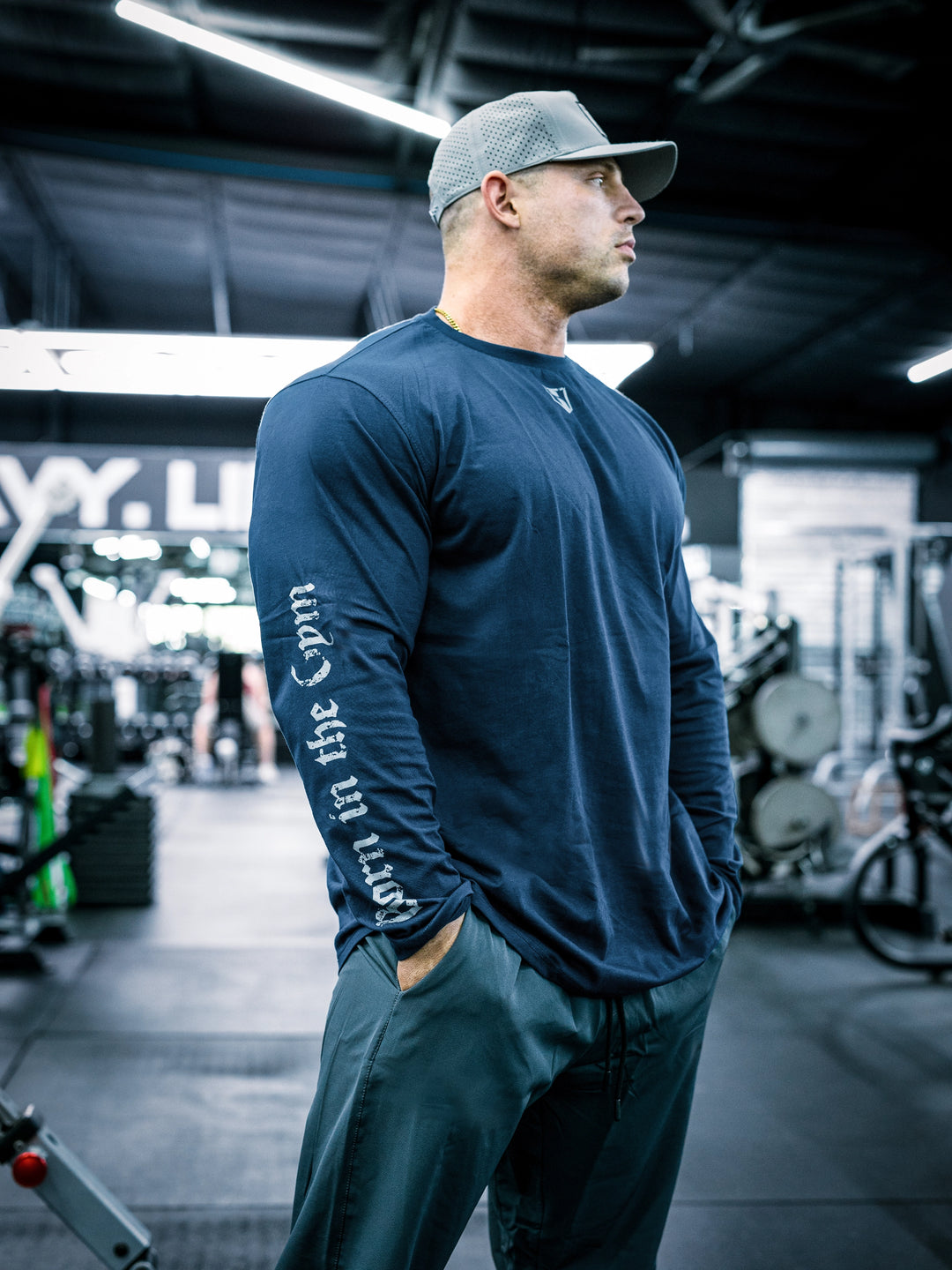 IFBB Pro Bodybuilder Martin Fitzwater wearing a black long-sleeve shirt with text in a gym setting#color_navy