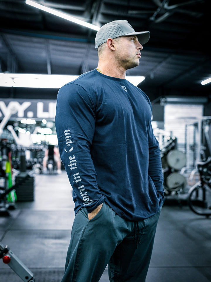 IFBB Pro Bodybuilder Martin Fitzwater wearing a black long-sleeve shirt with text in a gym setting#color_navy