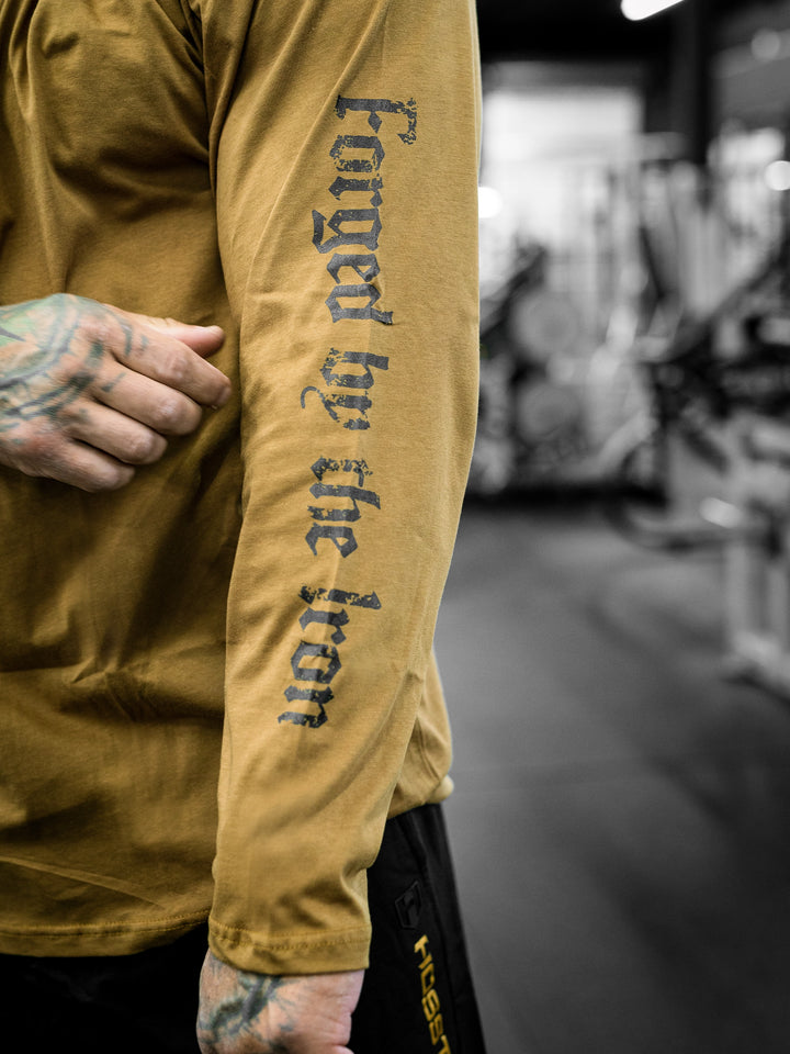 Bodybuilder Ben Chow wearing a black long-sleeve shirt with text in a gym setting#color_texas-clay