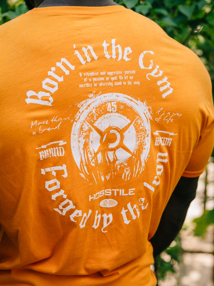 Bodybuilder Samson Dauda wearing the Forged Workout T-Shirt#color_orange