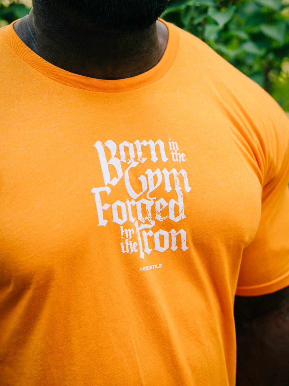 Bodybuilder Samson Dauda wearing the Forged Workout T-Shirt#color_orange