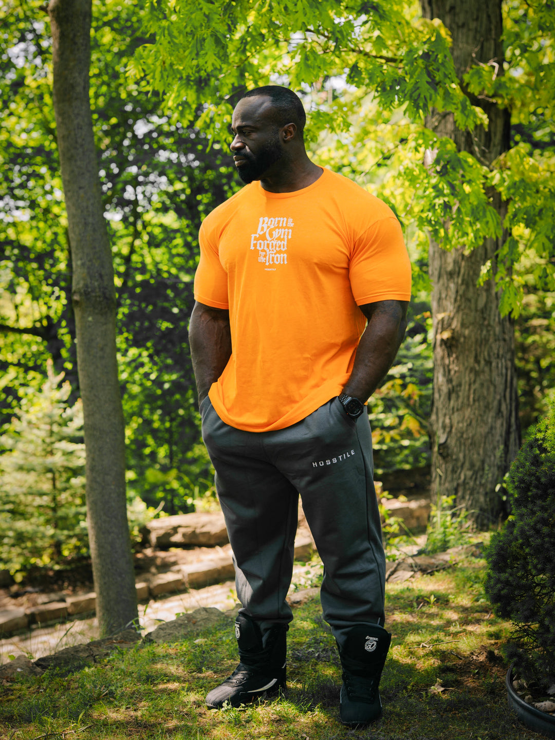 Bodybuilder Samson Dauda wearing the Forged Workout T-Shirt#color_orange