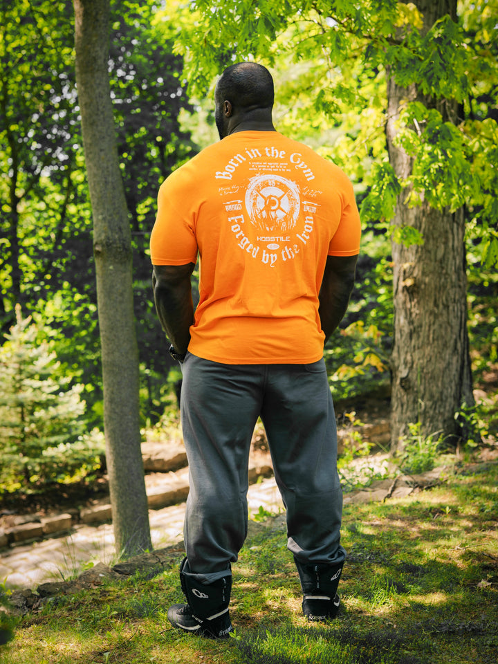 Bodybuilder Samson Dauda wearing the Forged Workout T-Shirt#color_orange