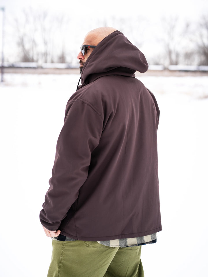 Bodybuilder wearing the Forged Jacket outdoors#color_brown