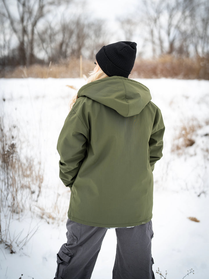 Bodybuilder wearing the Forged Jacket outdoors#color_military-green