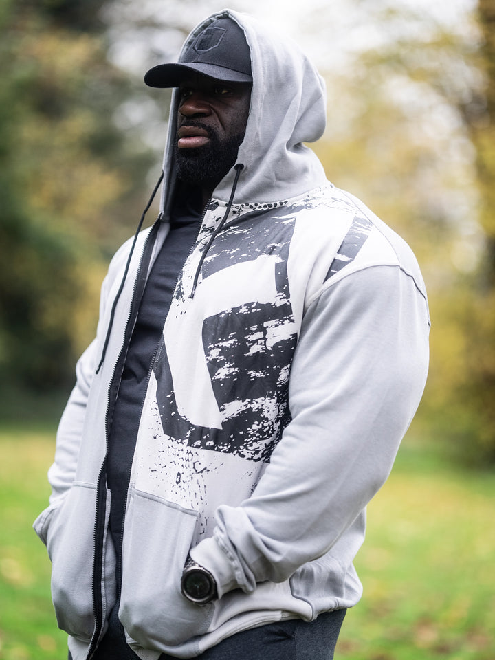 Bodybuilder Samson Dauda wearing the Fractured Zip-Up Hoodie#color_smoke