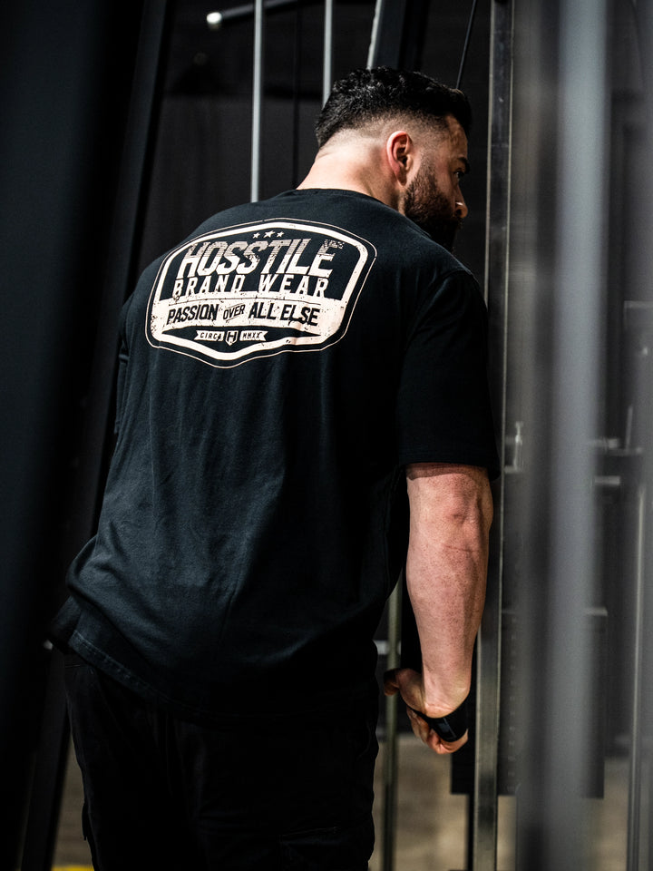 Bodybuilder wearing the Hosstile Garage Tee#color_black