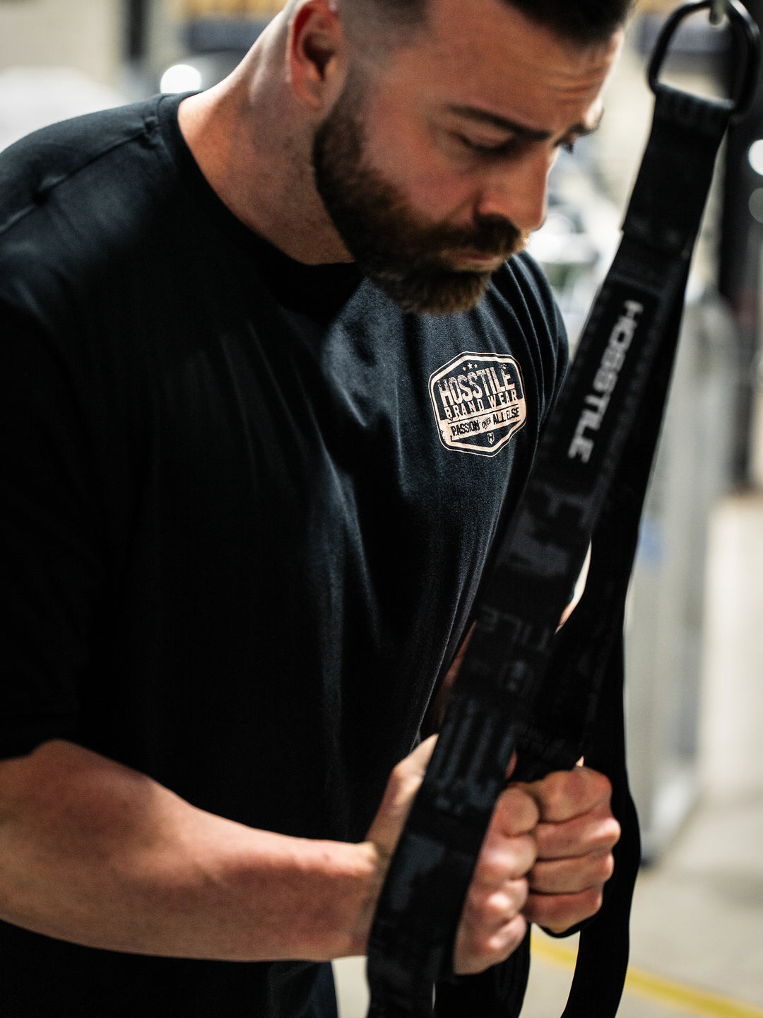 Bodybuilder wearing the Hosstile Garage Tee#color_black