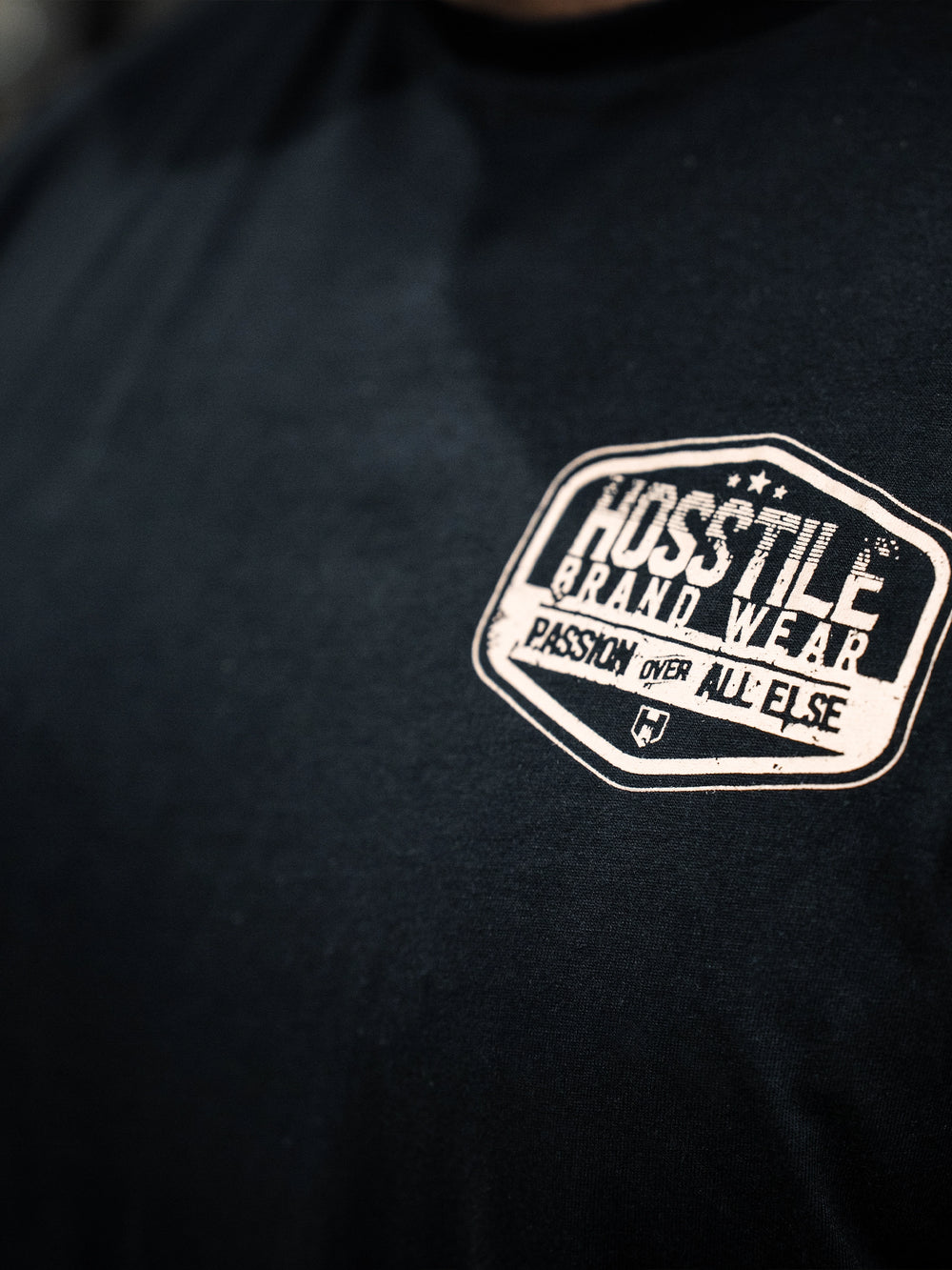 Bodybuilder wearing the Hosstile Garage Tee#color_black