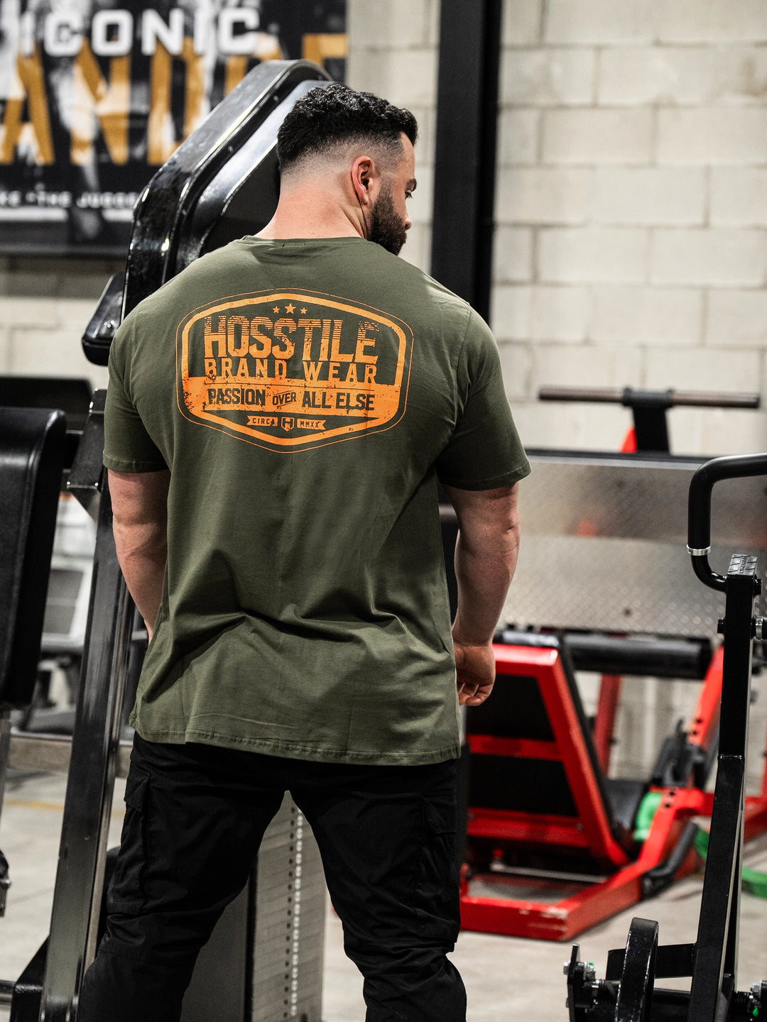 Bodybuilder wearing the Hosstile Garage Tee#color_military-green