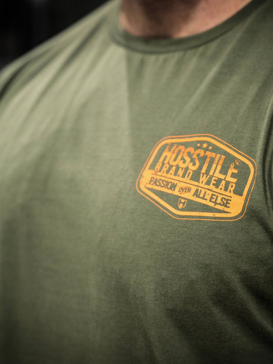 Bodybuilder wearing the Hosstile Garage Tee#color_military-green