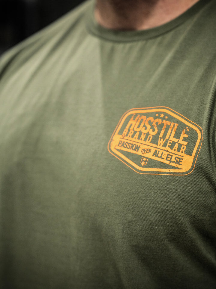 Bodybuilder wearing the Hosstile Garage Tee#color_military-green
