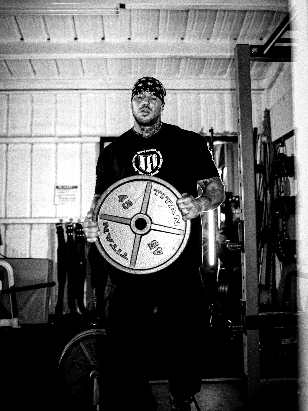 Bodybuilder wearing the Heavy Iron Tee while training in the gym#color_black