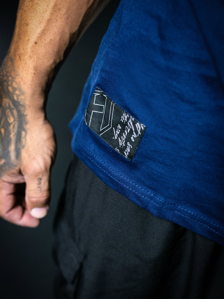 Close-up of a blue garment with a brand label on a dark background#color_navy