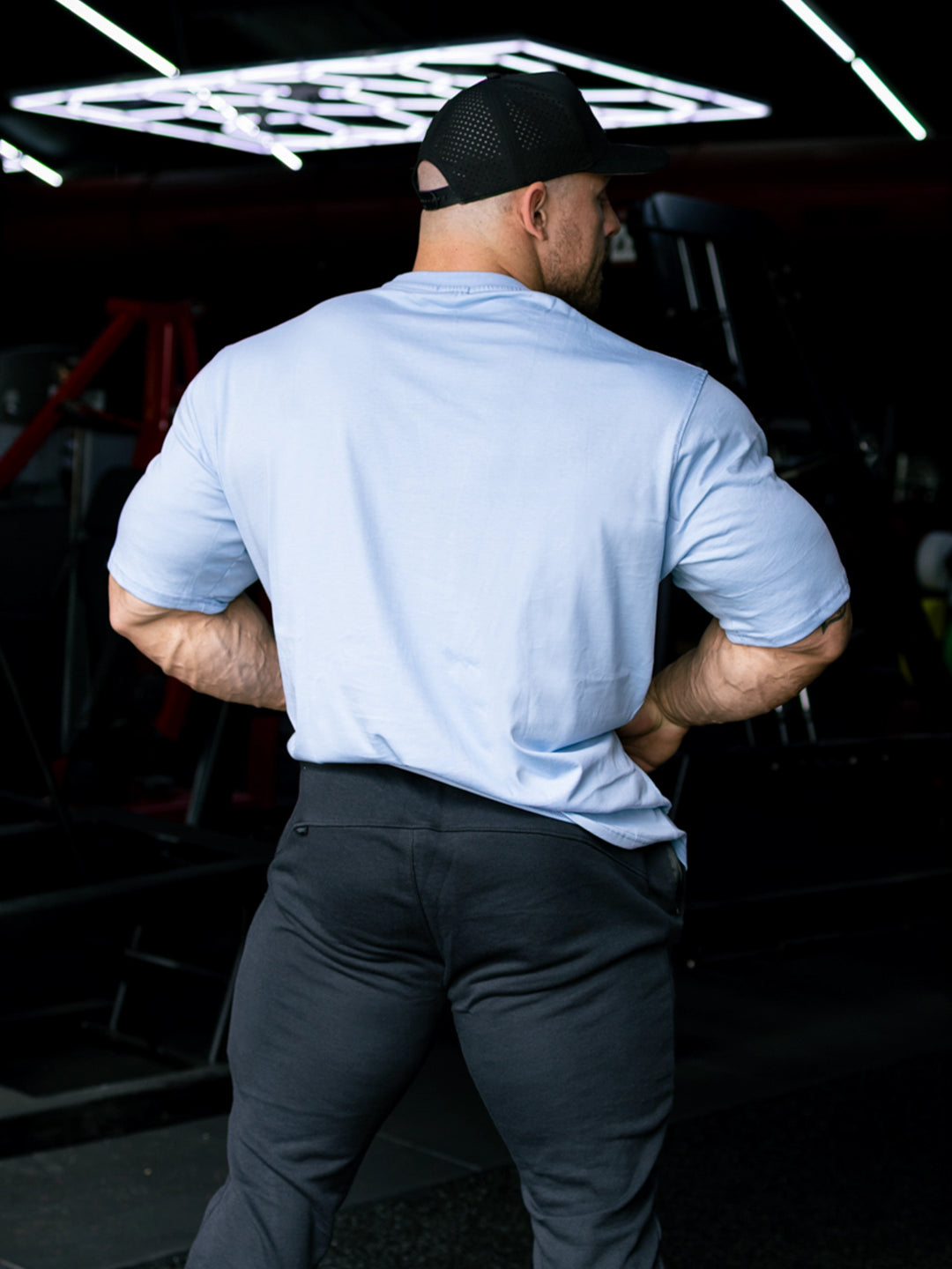 Martin Fitzwater wearing the Insignia t-shirt in a gym#color_ice-blue