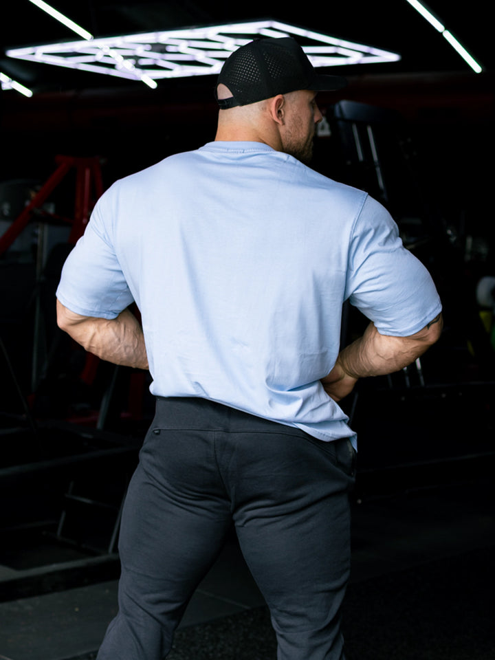 Martin Fitzwater wearing the Insignia t-shirt in a gym#color_ice-blue