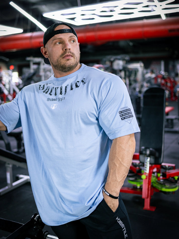 Martin Fitzwater wearing the Insignia t-shirt in a gym#color_ice-blue