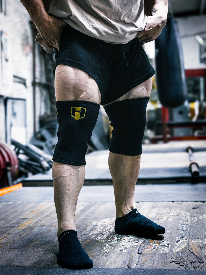 Bodybuilder Martin Fitzwater wearing Hosstile Heavy Duty Neoprene Knee Sleeves in the gym