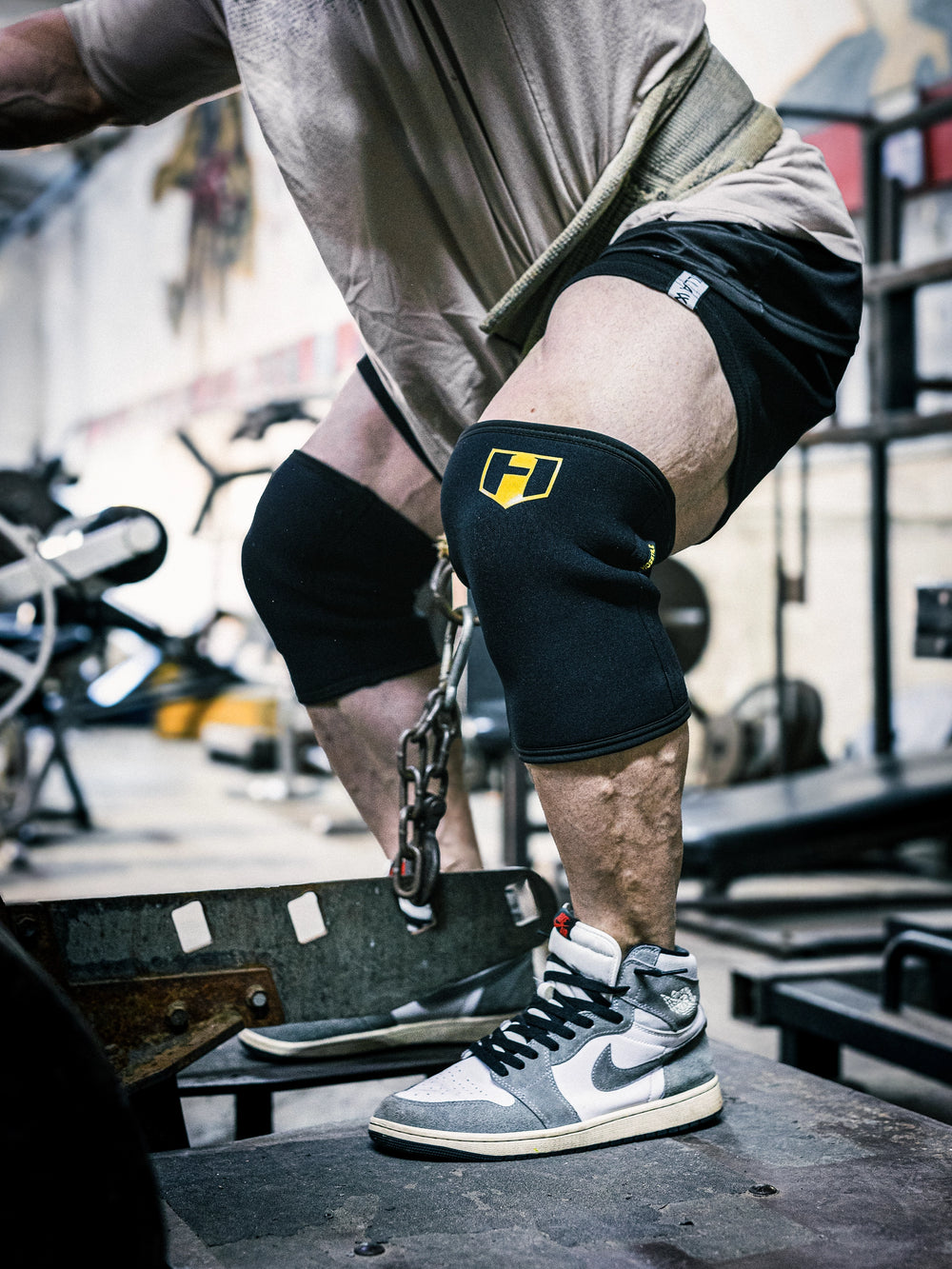 Bodybuilder Martin Fitzwater wearing Hosstile Heavy Duty Neoprene Knee Sleeves in the gym