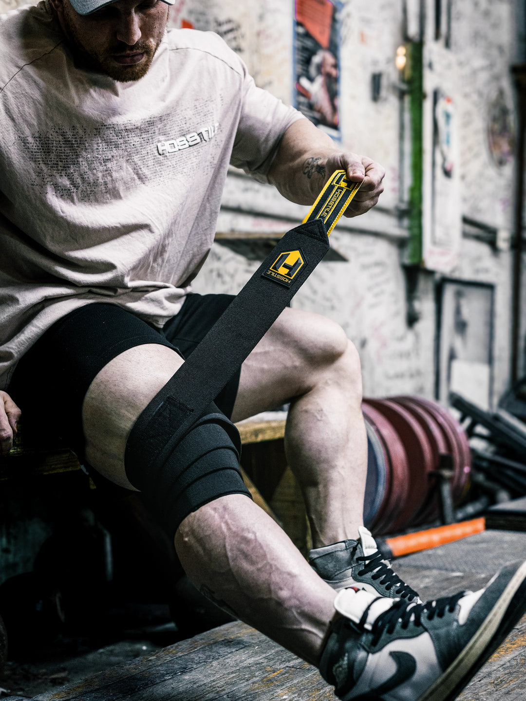 Bodybuilder Martin Fitzwater wearing Hosstile Heavy Duty Knee Wraps in the gym