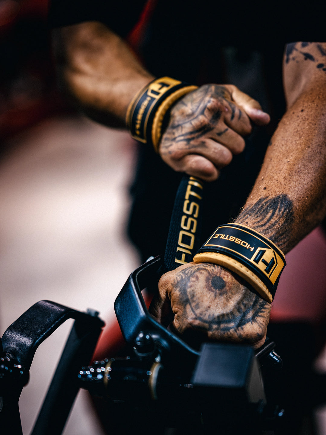 Bodybuilder wearing the Hosstile Padded Lifting Straps in the gym