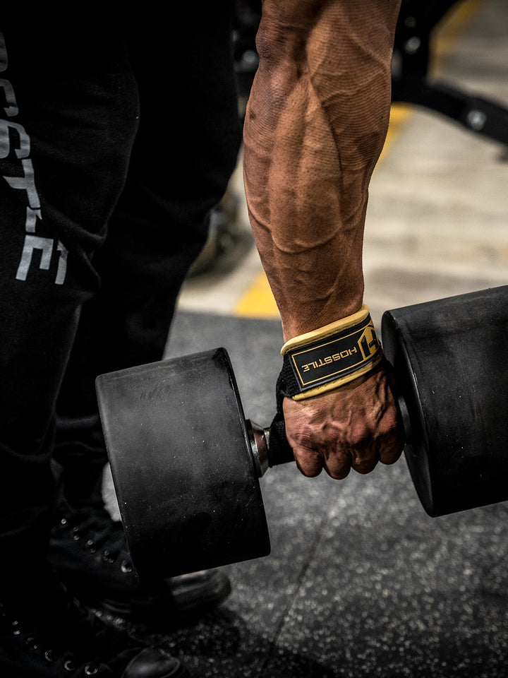 Bodybuilder wearing the Hosstile Padded Lifting Straps in the gym