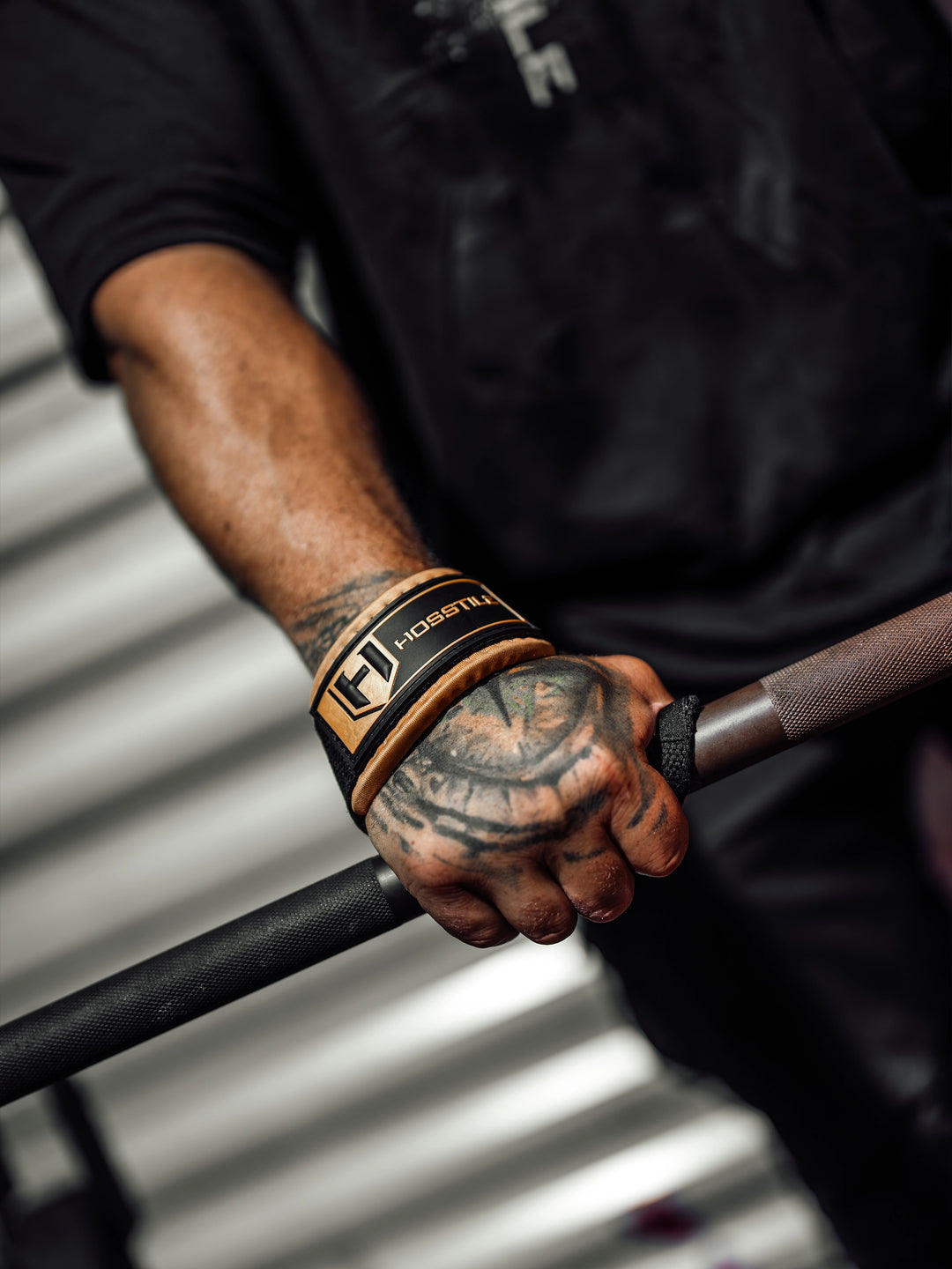 Bodybuilder wearing the Hosstile Padded Lifting Straps in the gym