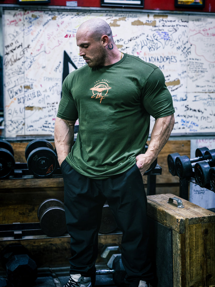 Bodybuilder Martin Fitzwater wearing the MF Vintage T-Shirt in the gym#color_forest-green