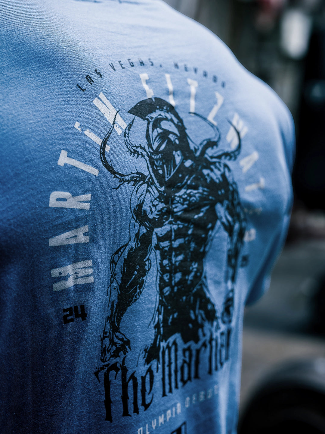 Bodybuilder Martin Fitzwater wearing the Invasion T-Shirt in the gym#color_cool-blue