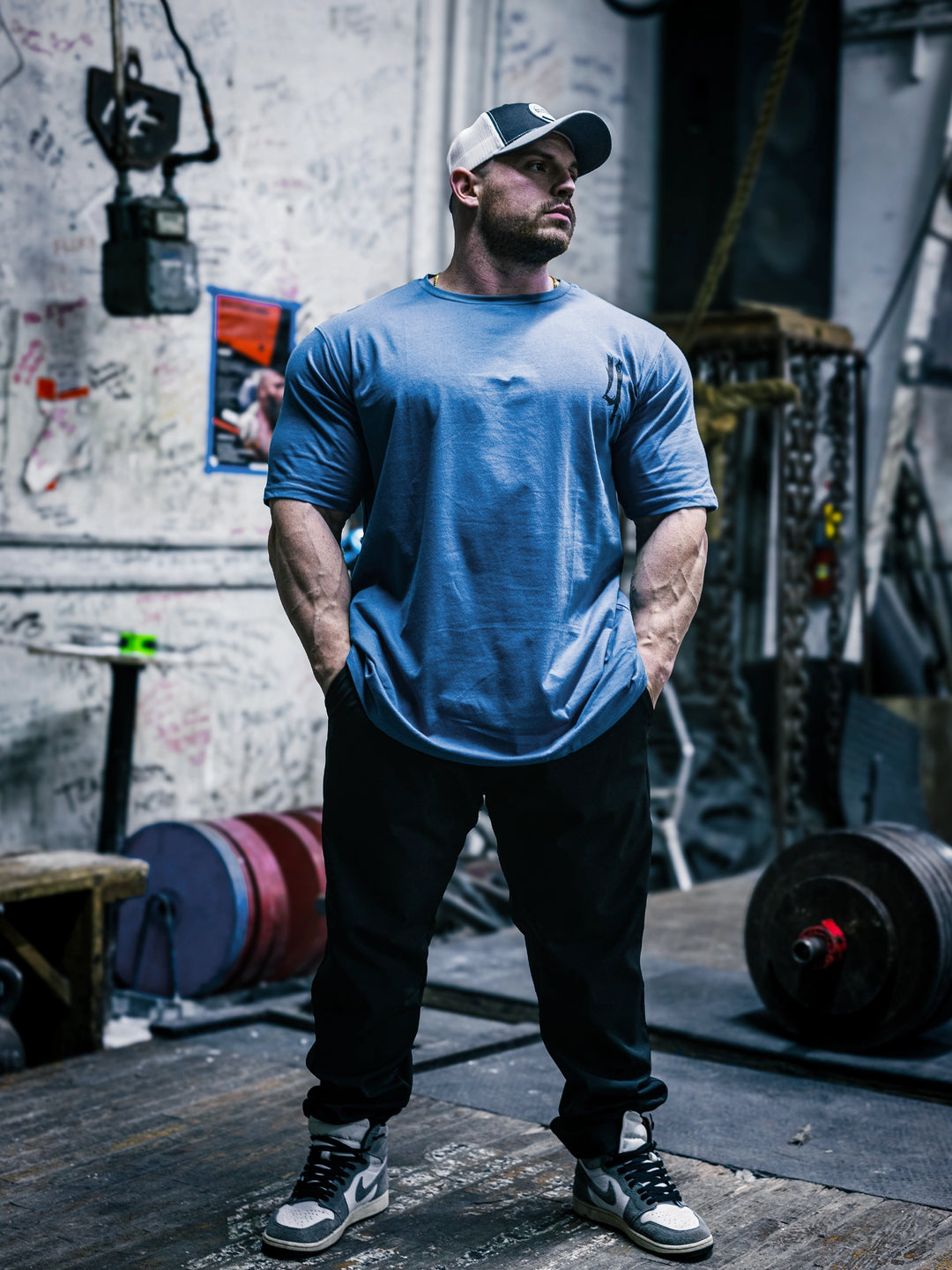 Bodybuilder Martin Fitzwater wearing the Invasion T-Shirt in the gym#color_cool-blue