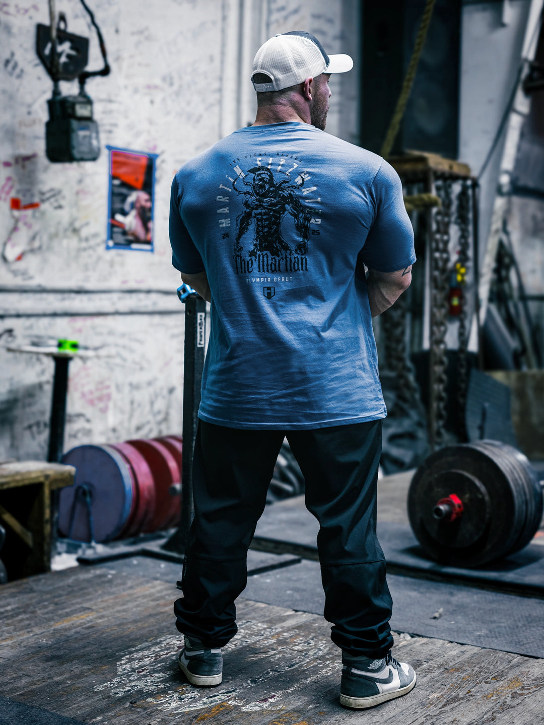 Bodybuilder Martin Fitzwater wearing the Invasion T-Shirt in the gym#color_cool-blue