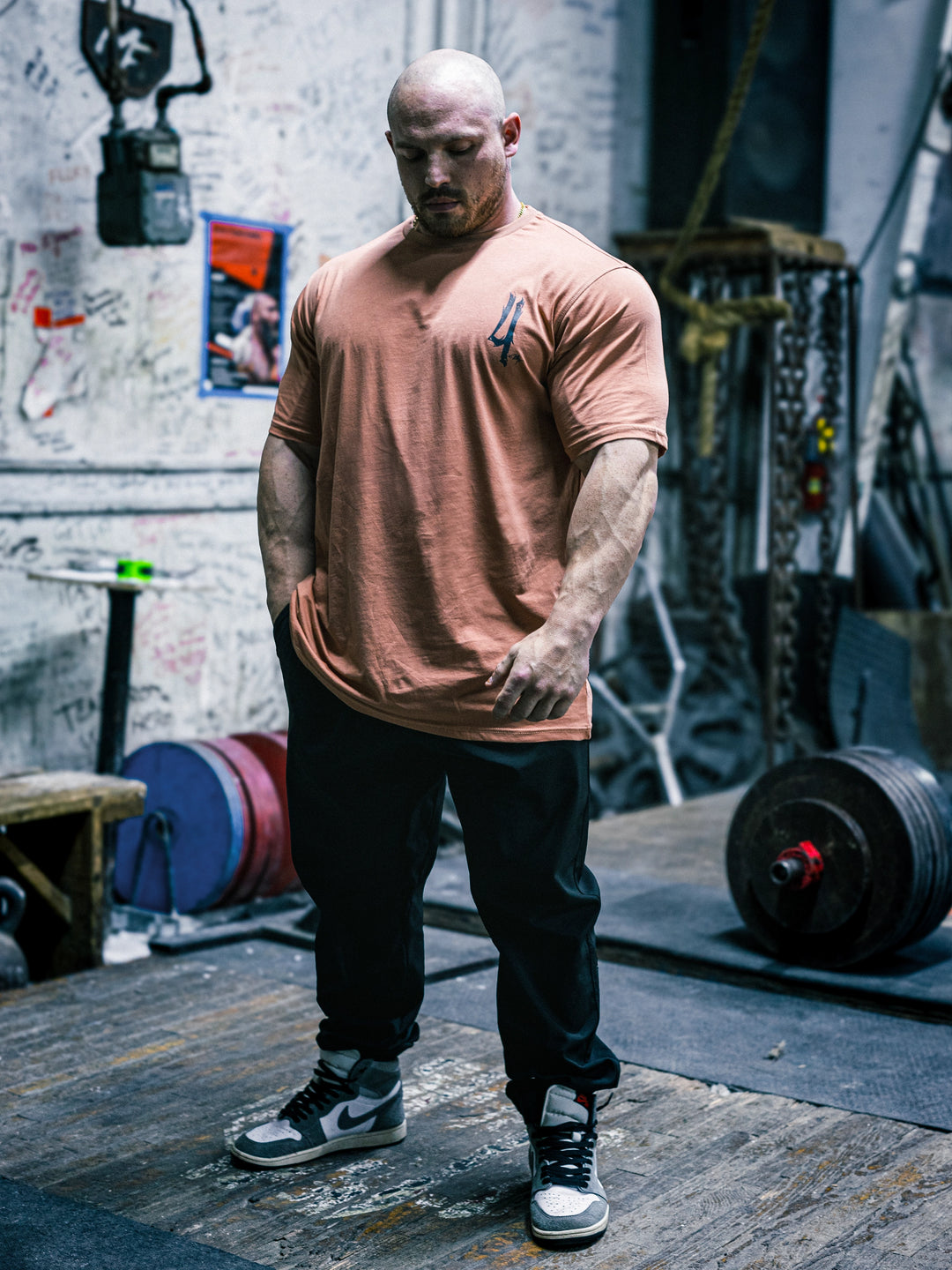 Bodybuilder Martin Fitzwater wearing the Invasion T-Shirt in the gym#color_coral