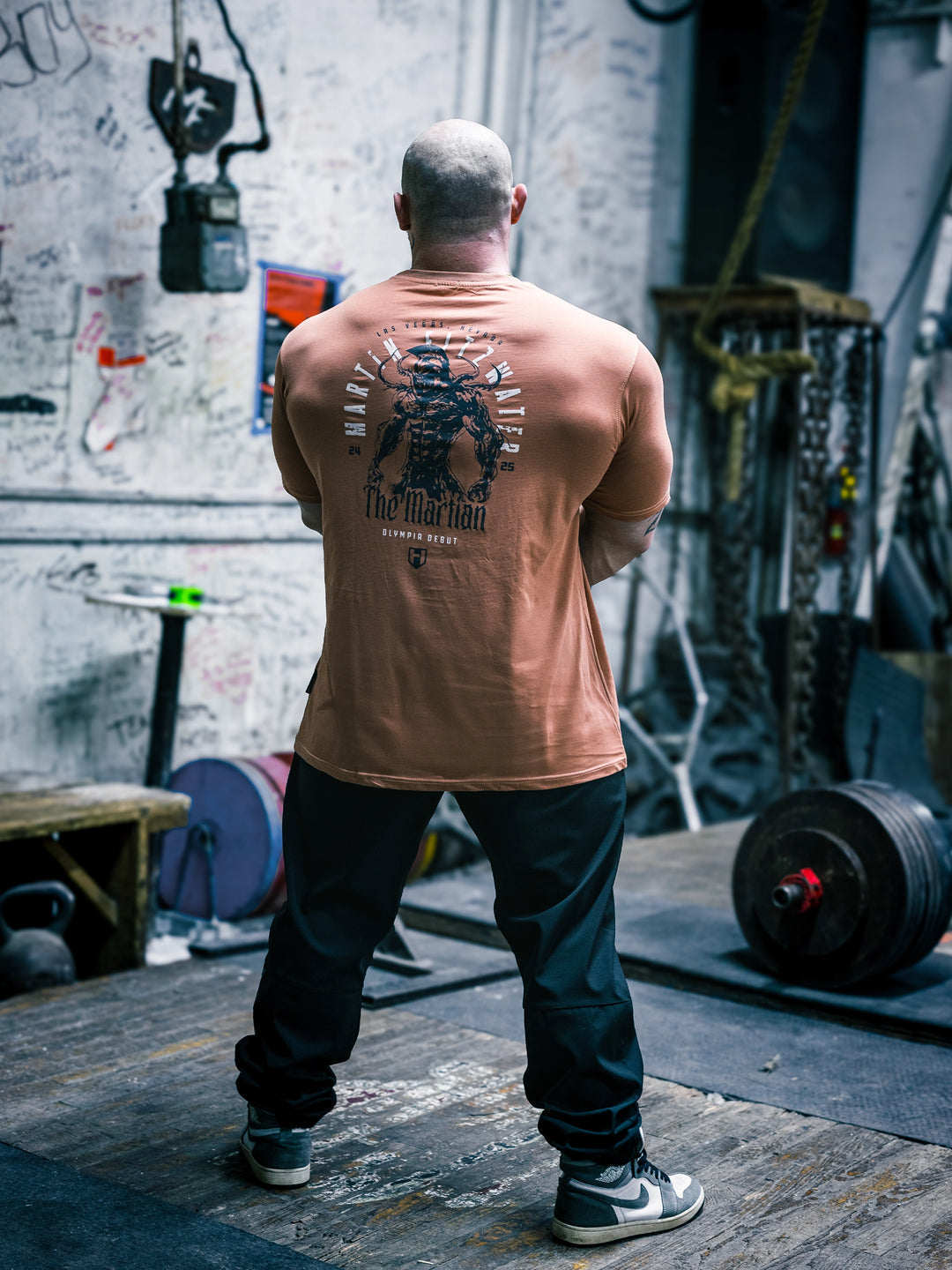 Bodybuilder Martin Fitzwater wearing the Invasion T-Shirt in the gym#color_coral