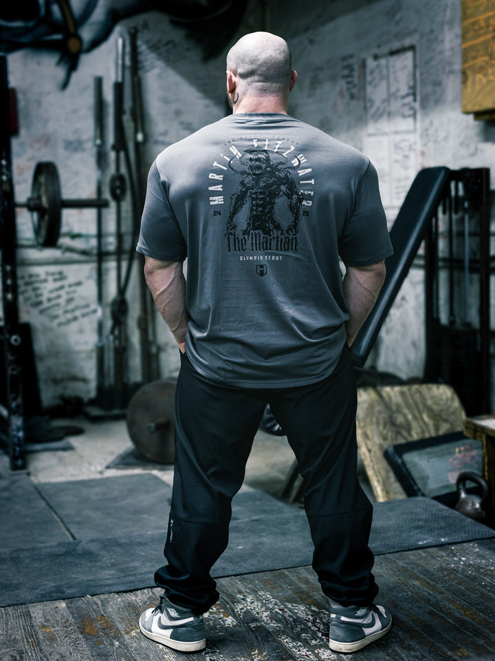 Bodybuilder Martin Fitzwater wearing the Invasion T-Shirt in the gym#color_grey