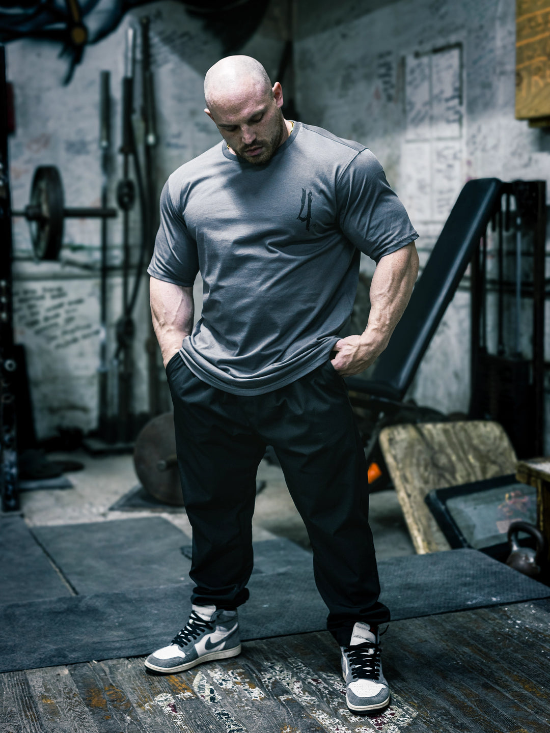 Bodybuilder Martin Fitzwater wearing the Invasion T-Shirt in the gym#color_grey