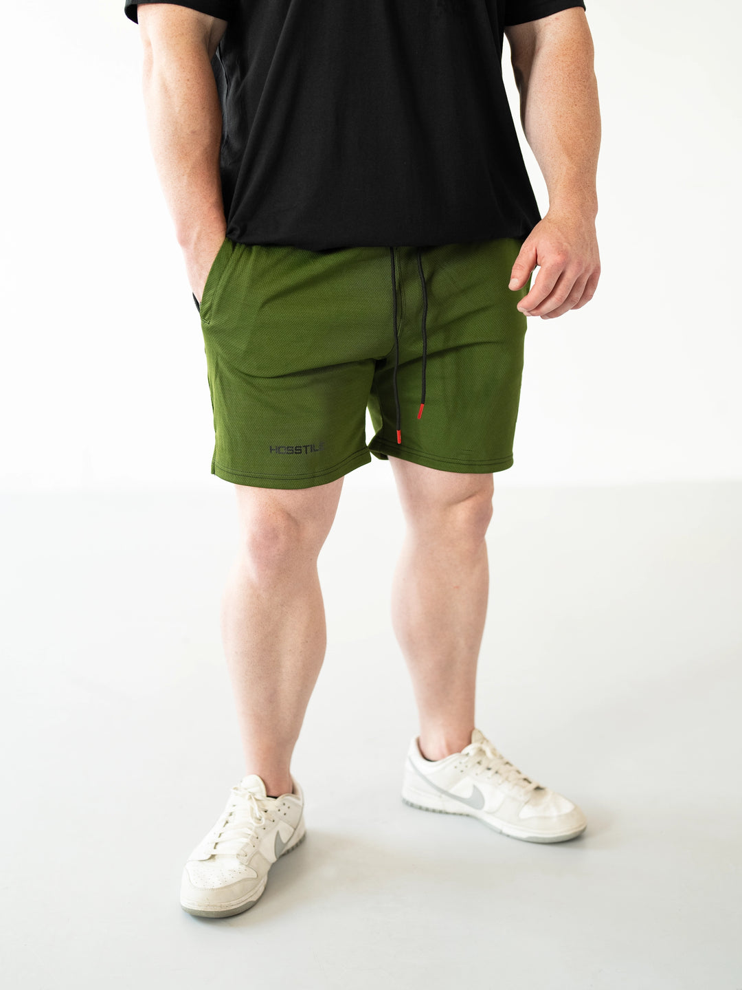 Bodybuilder Wearing Sacrifice Mesh Training Shorts#color_military-green