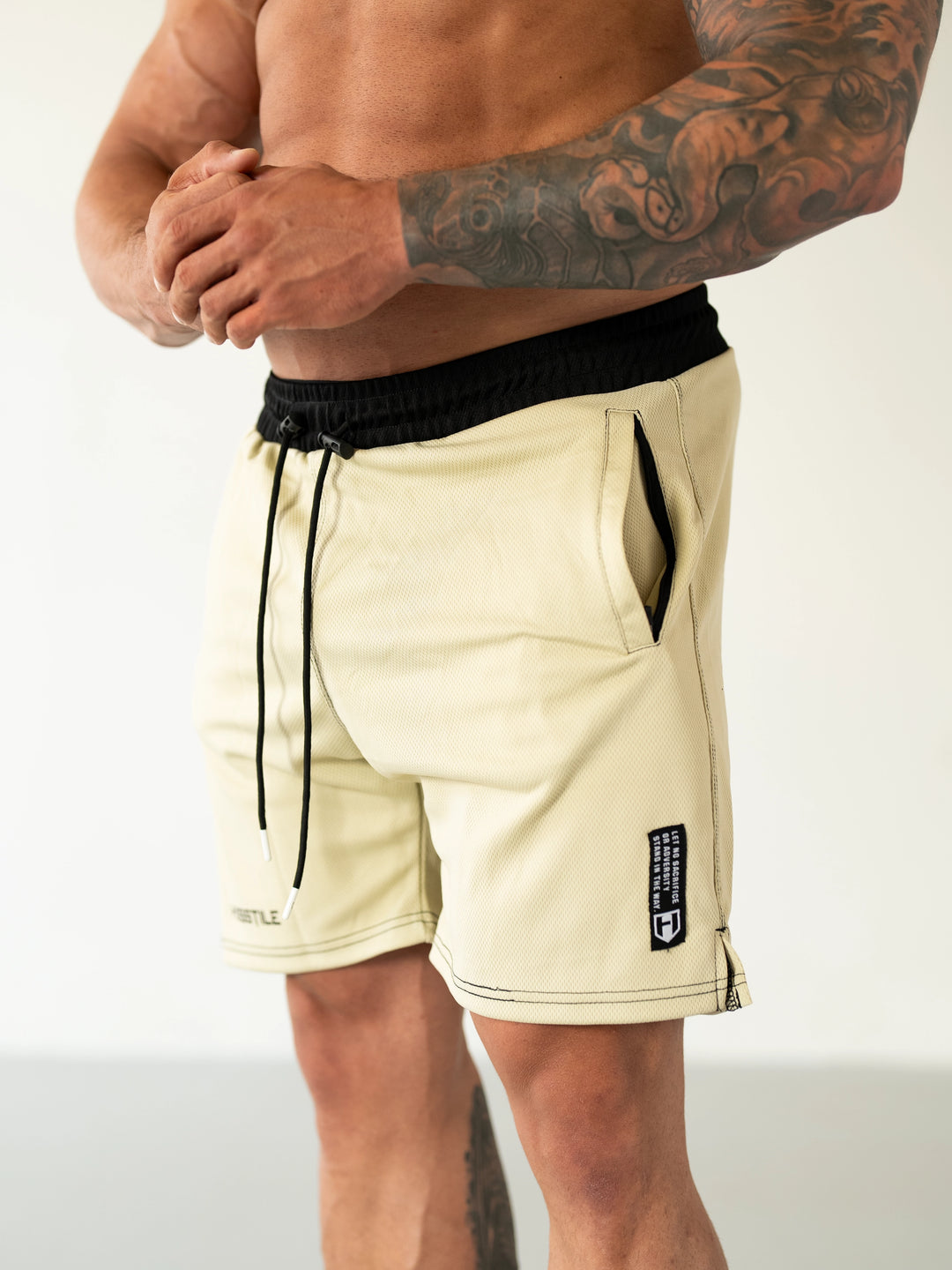 Bodybuilder Wearing Sacrifice Mesh Training Shorts#color_sand