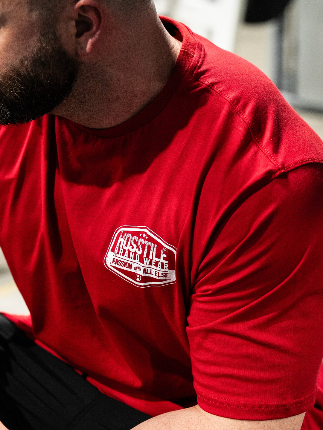 Bodybuilder wearing the Hosstile Club Work Tee#color_red