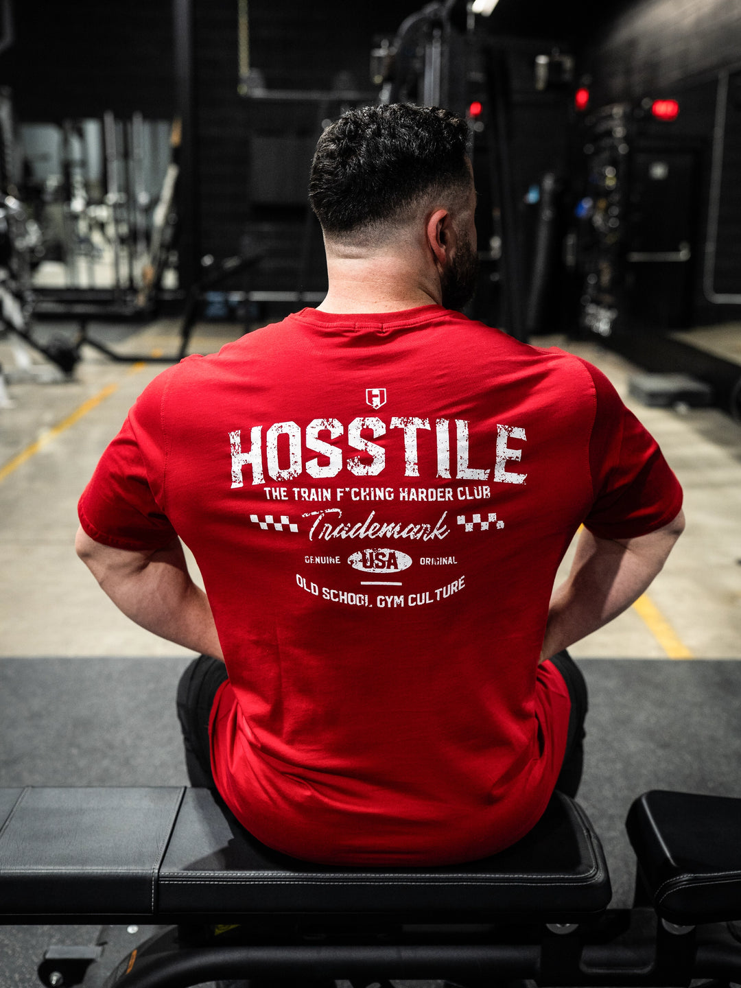 Bodybuilder wearing the Hosstile Club Work Tee#color_red