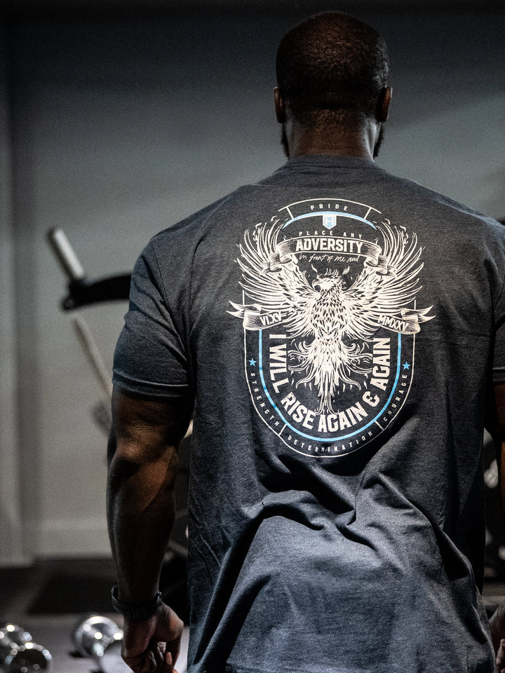 Person wearing a black t-shirt with a motivational design in a gym setting#color_navy