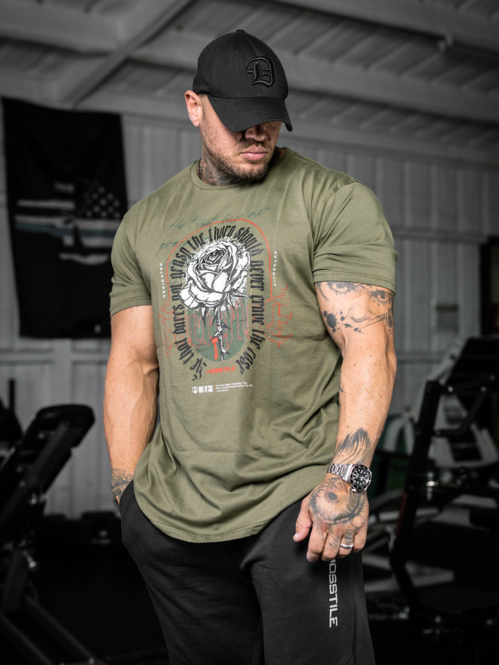 bodybuilder wearing the Rose & Thorn Men's Graphic Gym T-Shirt#color_military-green