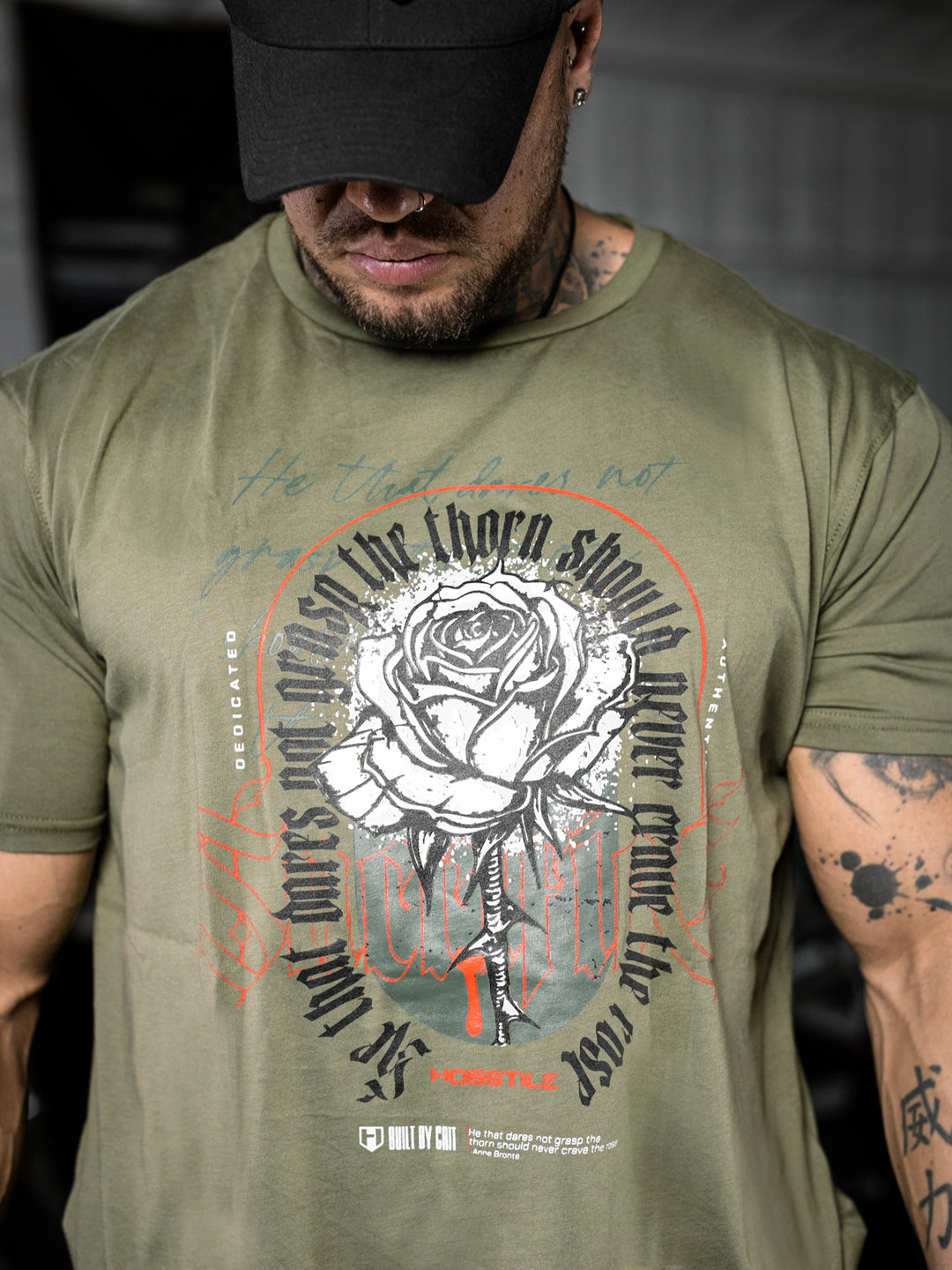 bodybuilder wearing the Rose & Thorn Men's Graphic Gym T-Shirt#color_military-green