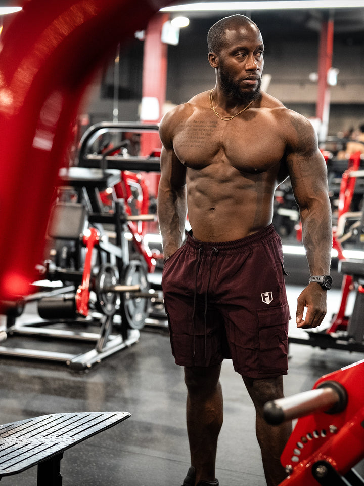 Bodybuilder Wearing Shield Gym Cargo Shorts - Maroon#color_maroon