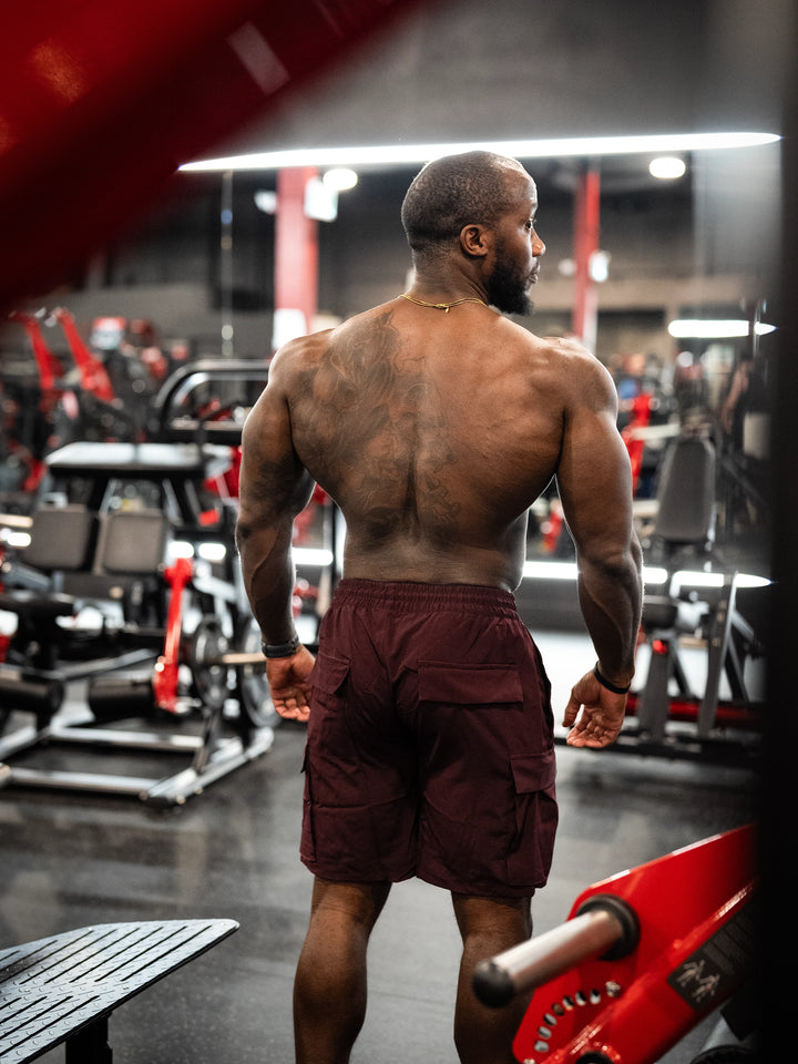Bodybuilder Wearing Shield Gym Cargo Shorts - Maroon#color_maroon