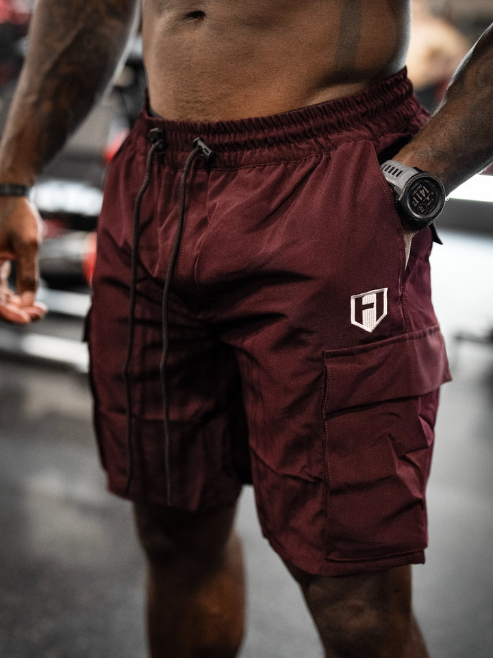 Bodybuilder Wearing Shield Gym Cargo Shorts - Maroon#color_maroon