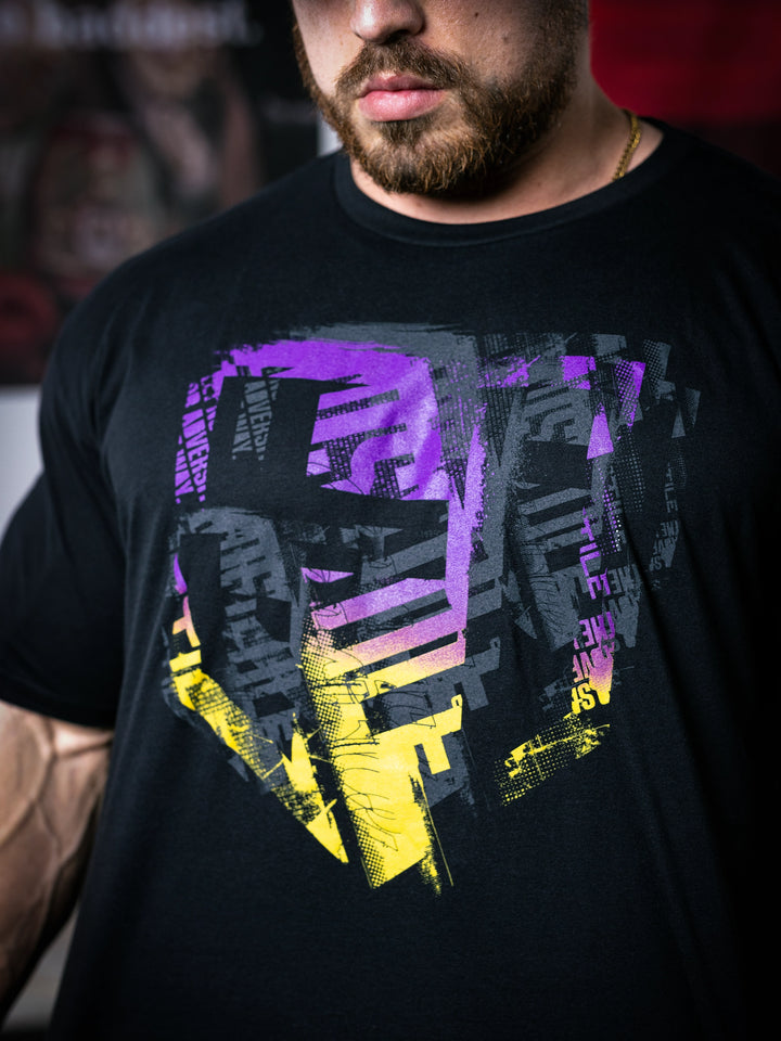 IFBB Pro Bodybuilder Martin Fitzwater wearing a black t-shirt with a graphic design and a cap, standing in a gym#color_black-african-sunrise